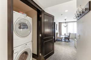 Recessed laundry closet featuring stacked front-load appliances