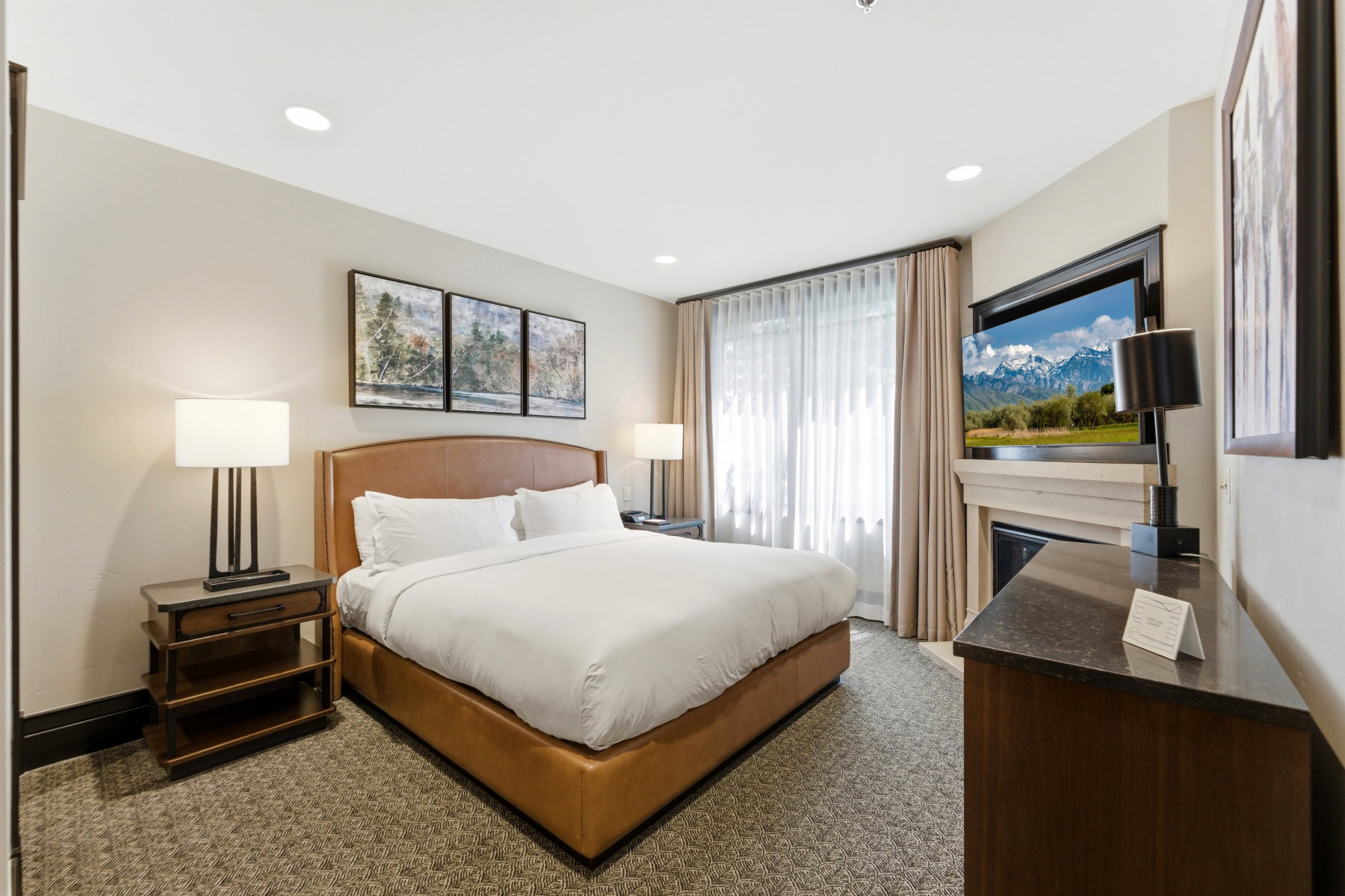 Carpeted room featuring recessed lighting and a window with sheer and blackout drapes