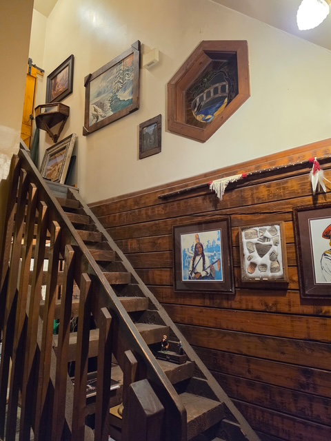 Custom wood-finish staircase with open risers and unique baluster design