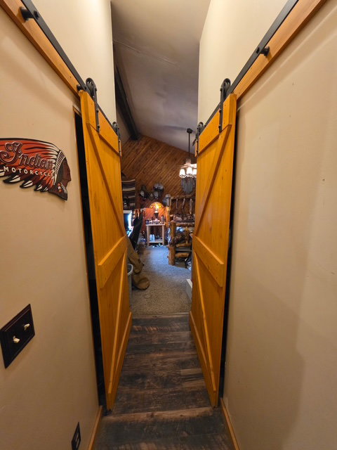 Dual wood-finish barn doors with black metal hardware