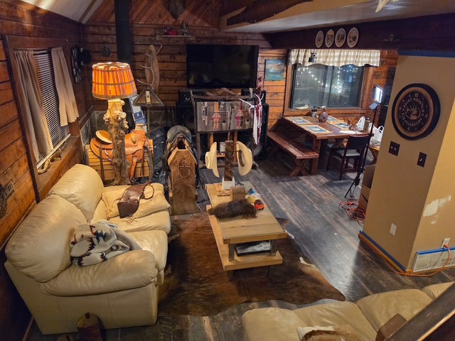 Interior living space featuring wood-paneled walls and wood-finish flooring