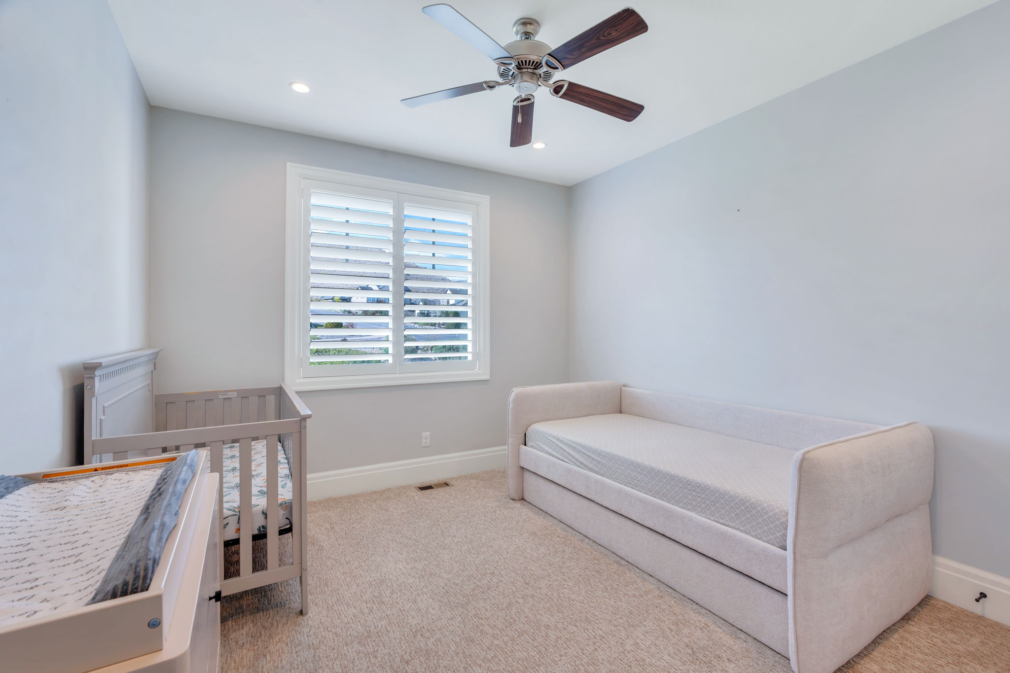 Neutral wall tones complement plush carpeting