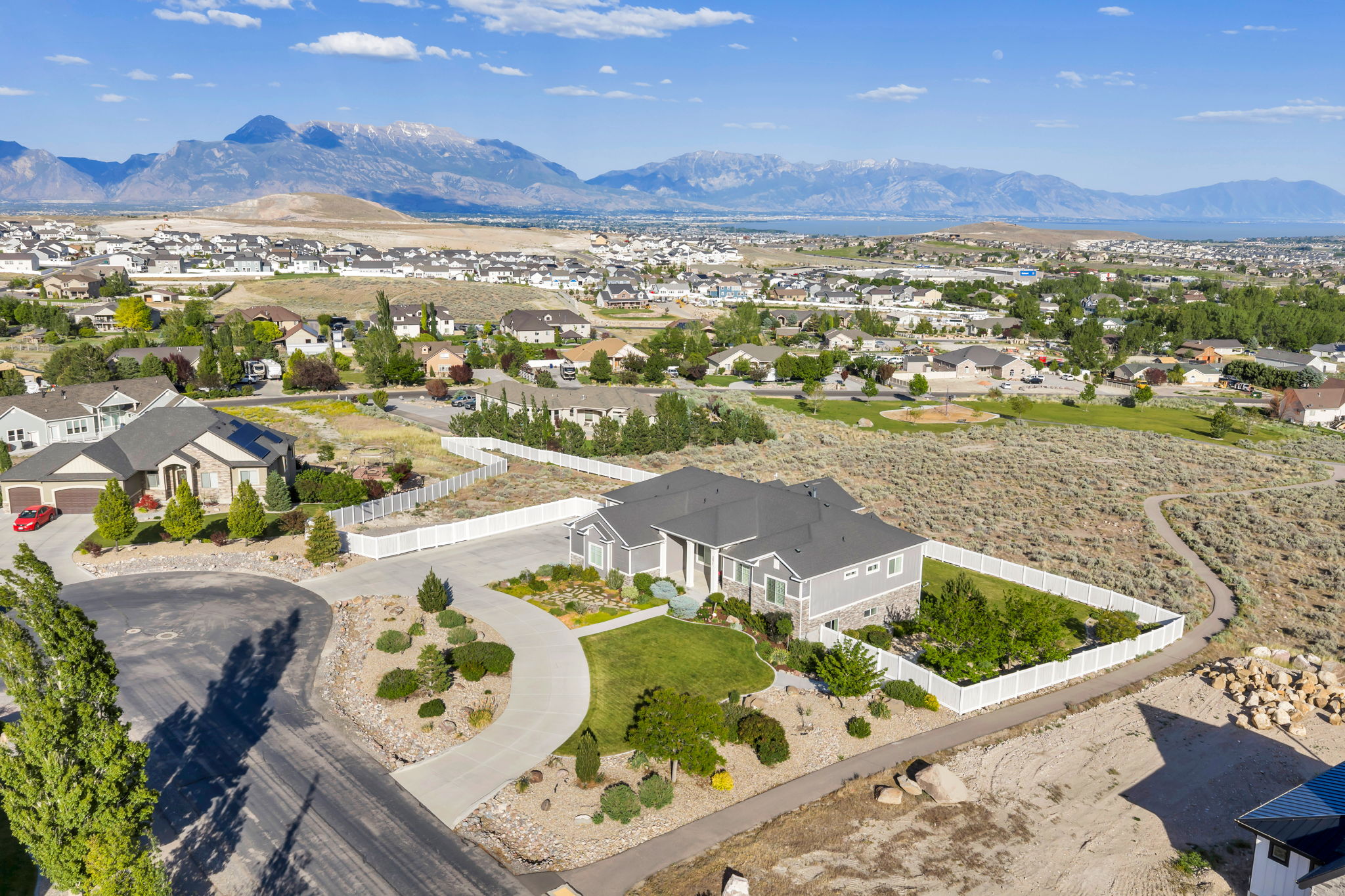 Contemporary gray exterior residence with white trim and a dark gray roof