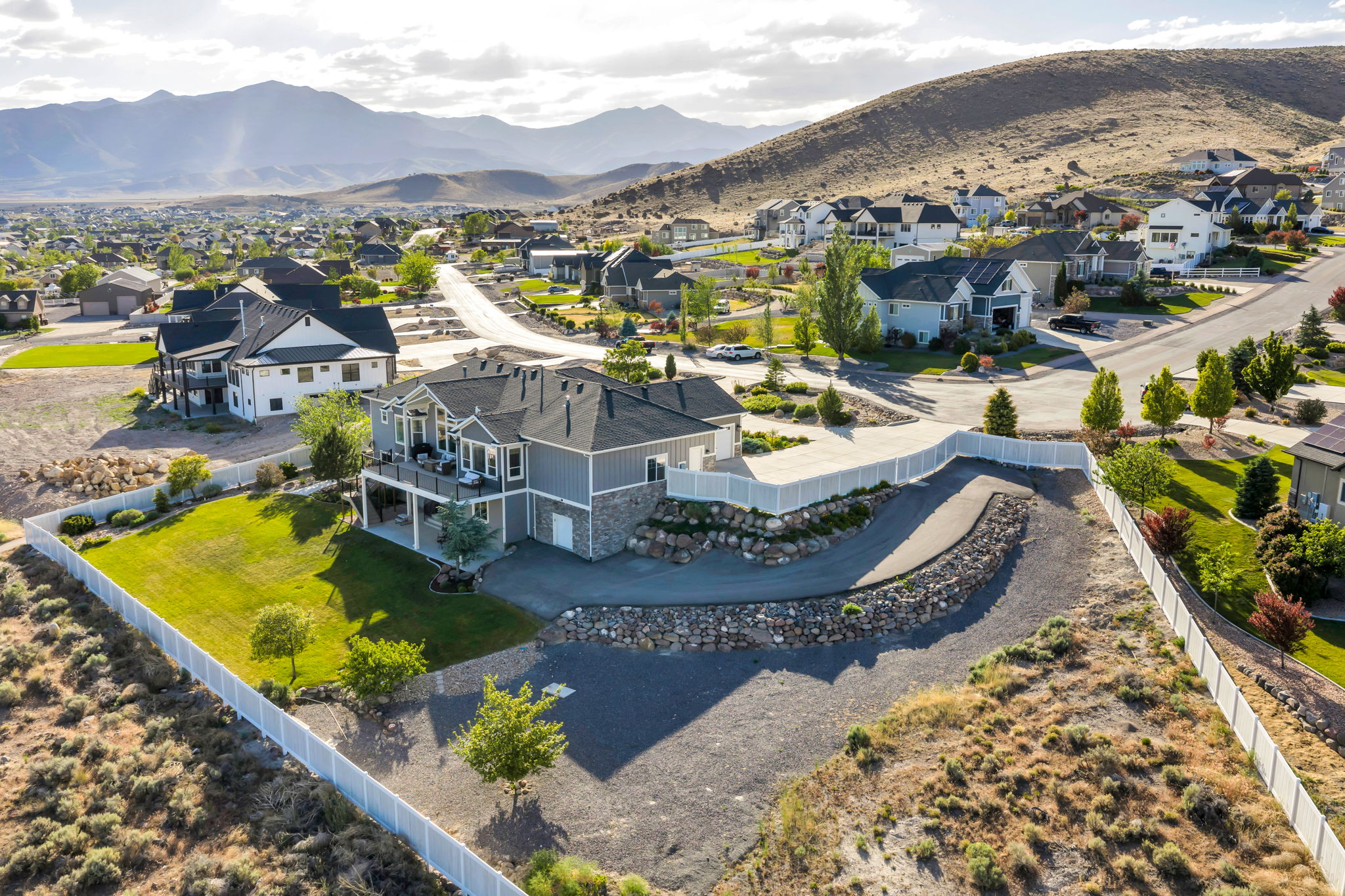 Contemporary residence featuring a split-level design with stone and siding exterior