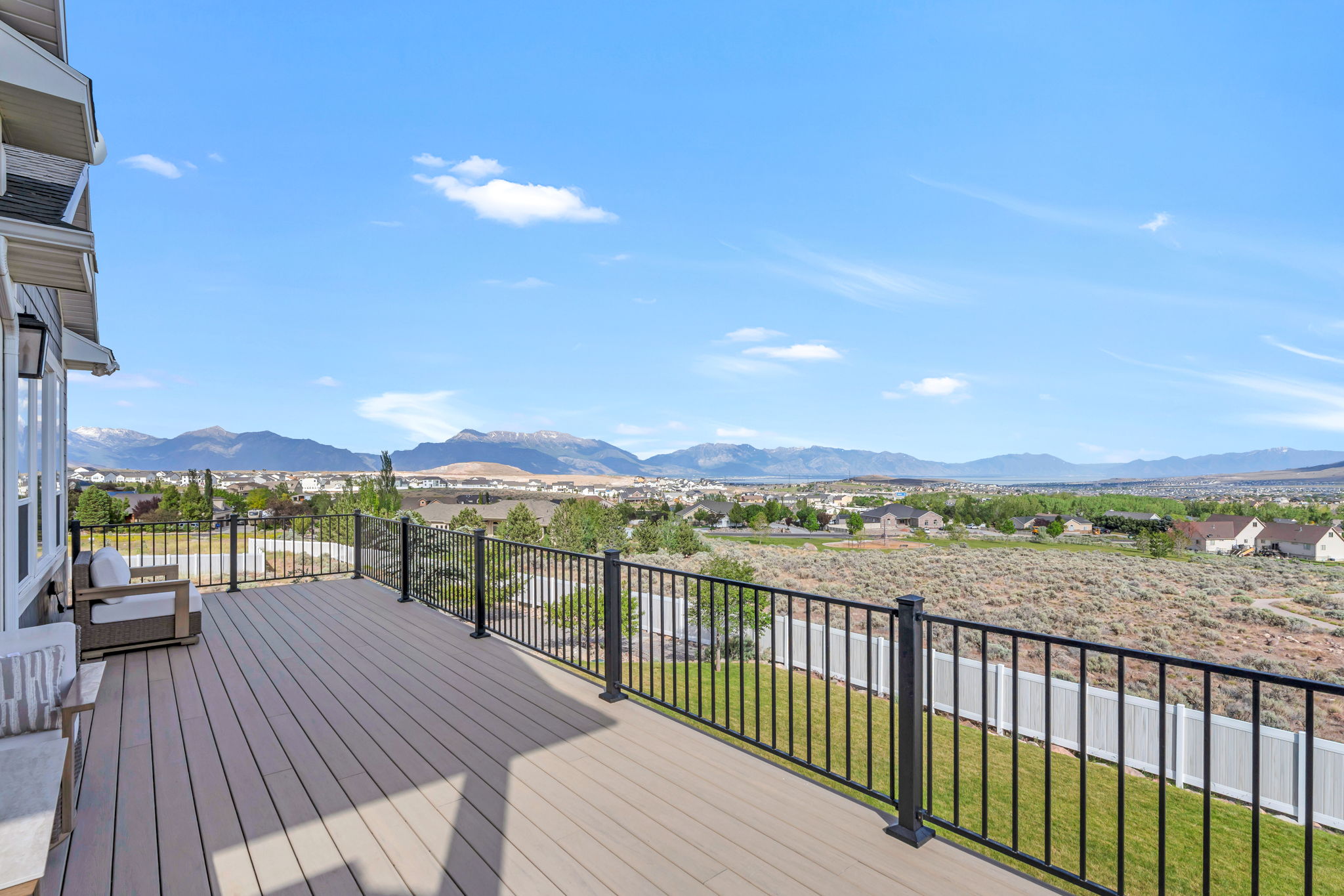 Expansive outdoor deck featuring composite decking and black metal railings