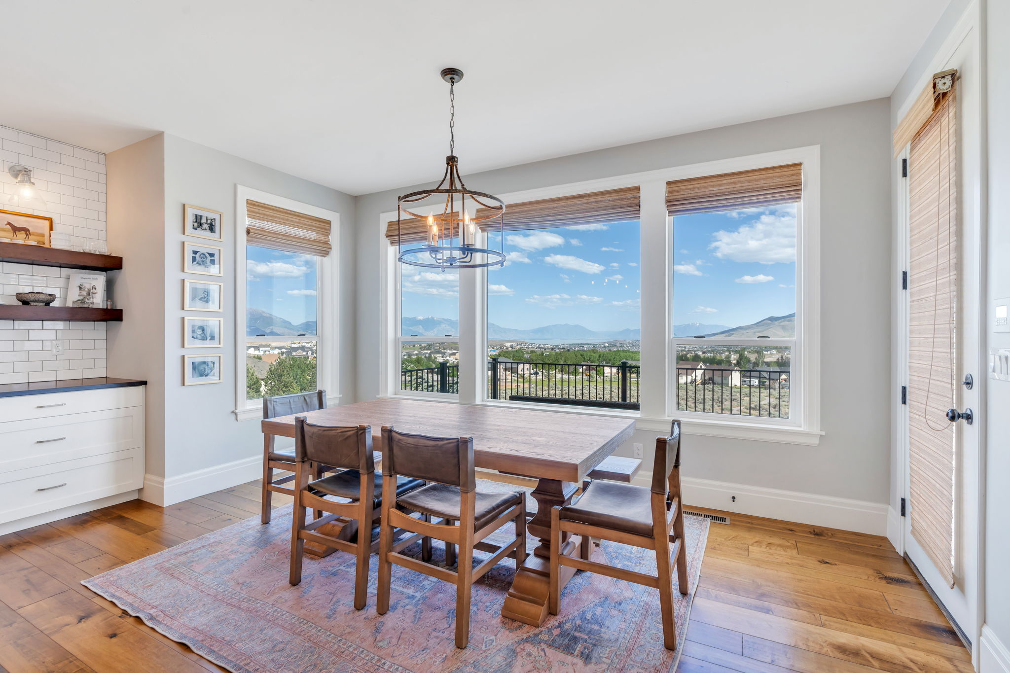 Dining area featuring hardwood flooring and a contemporary chandelier