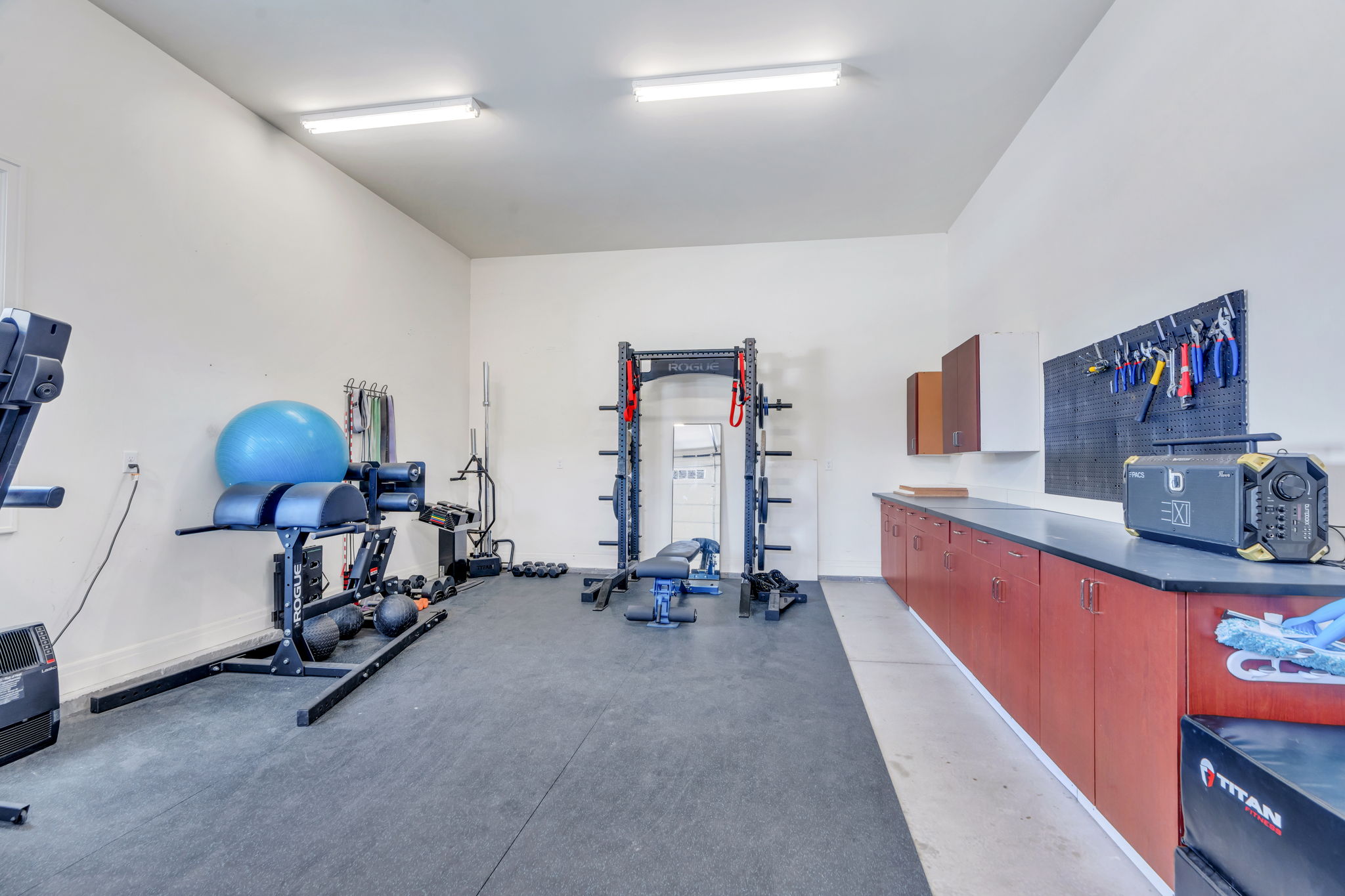 Spacious multi-purpose room featuring high ceilings and durable rubber flooring