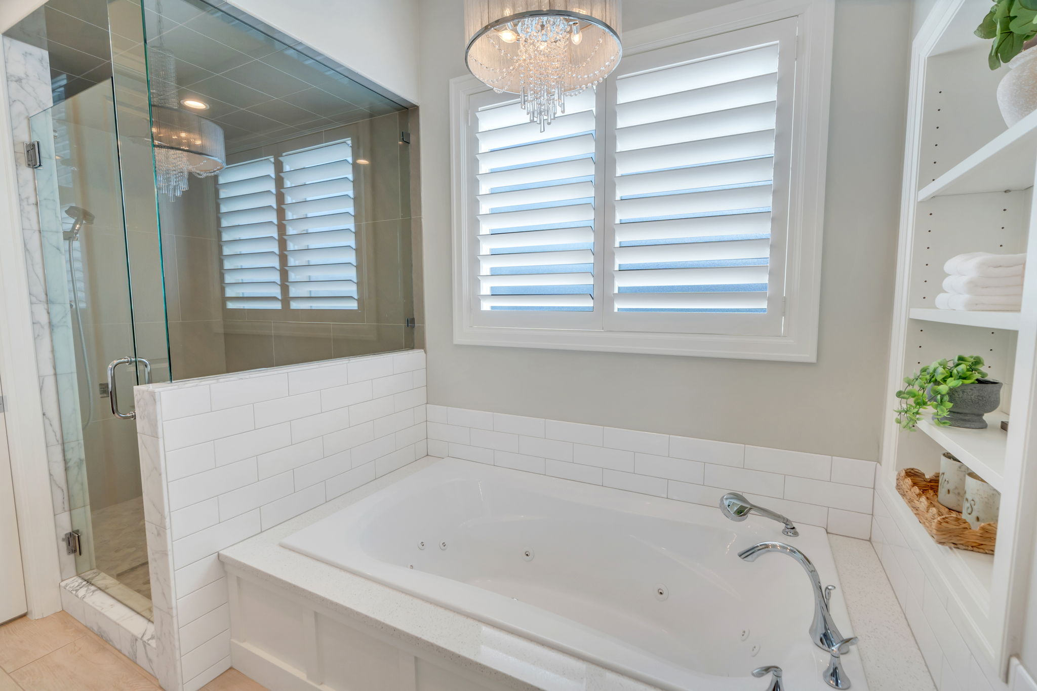 Soaking tub with jetted features, white subway tile surround, and a chrome faucet