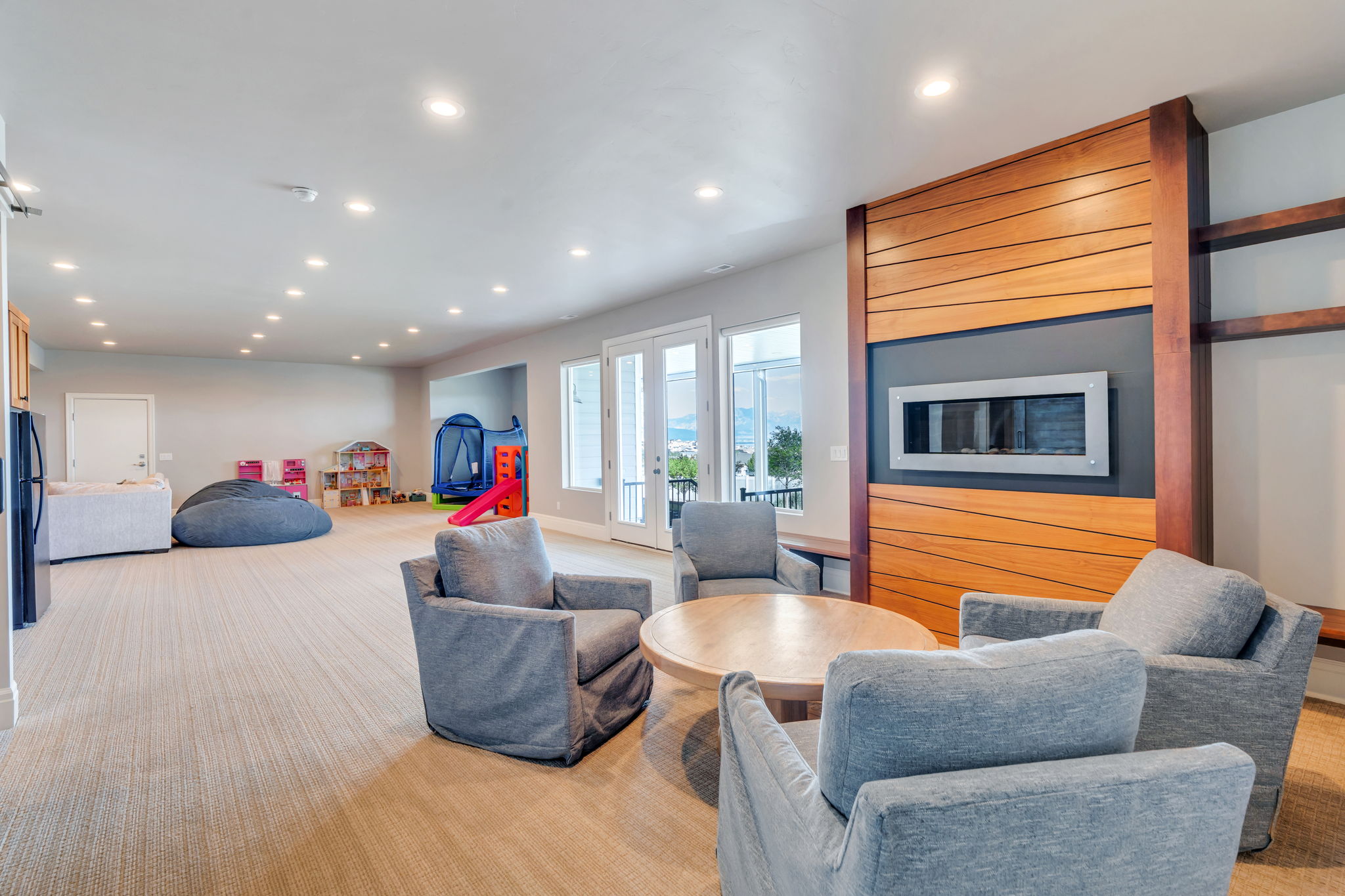 Spacious room featuring light-toned carpeting and recessed lighting