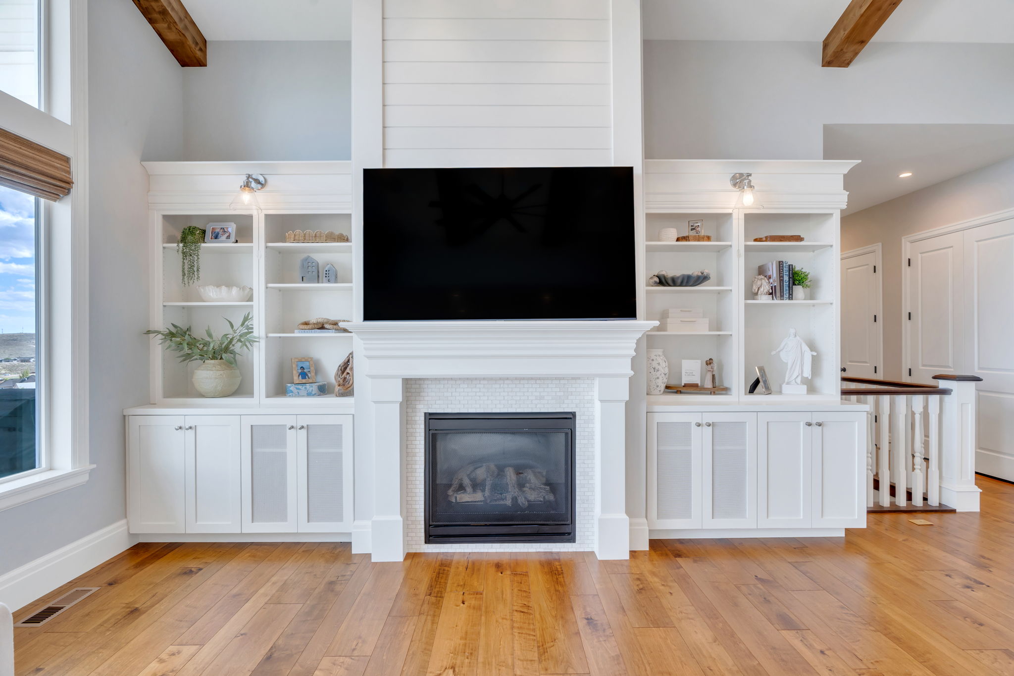 Living space featuring a central fireplace with white shiplap, hexagonal tile surround, and a classic mantel