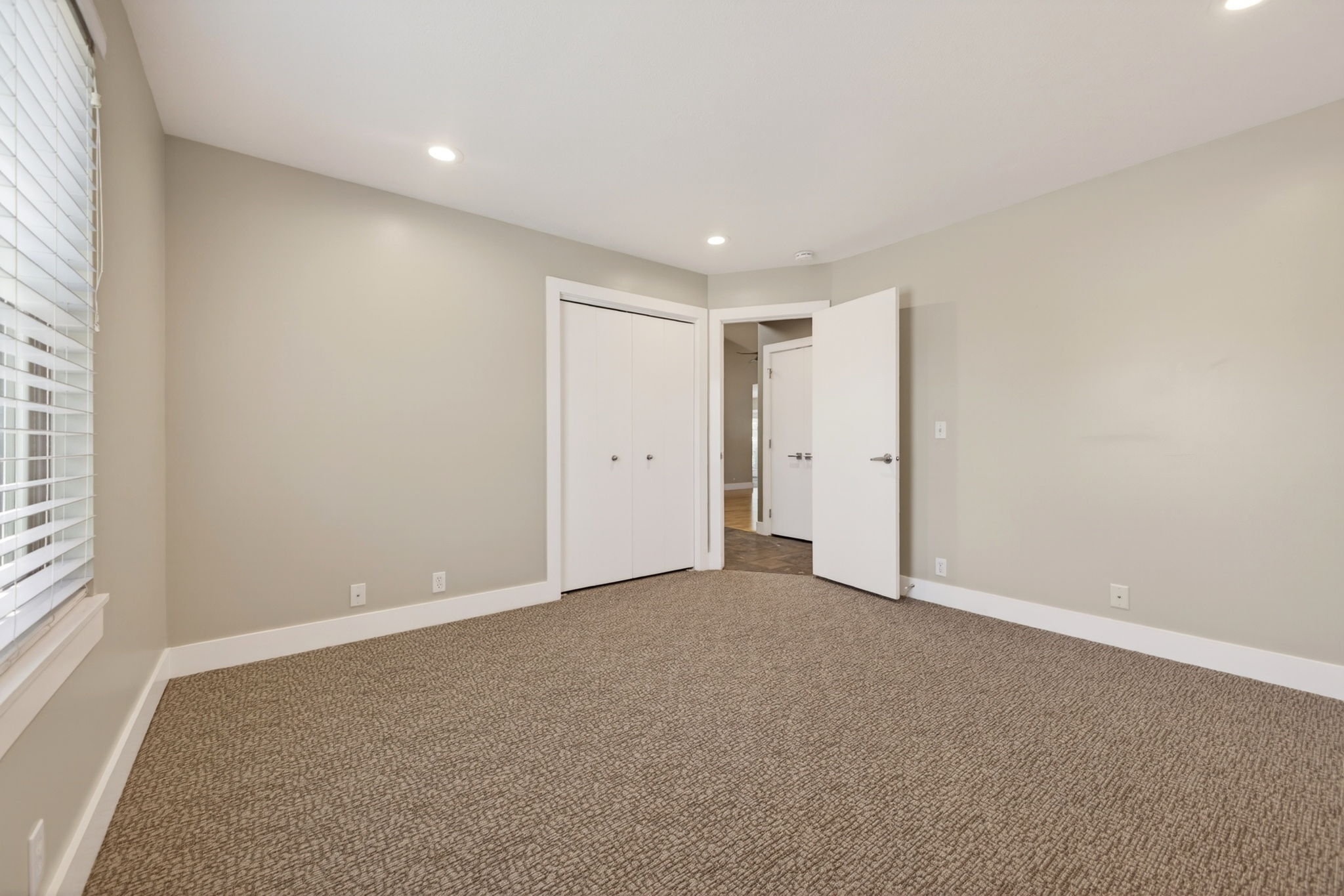 Carpeted bedroom featuring recessed lighting, and a large closet