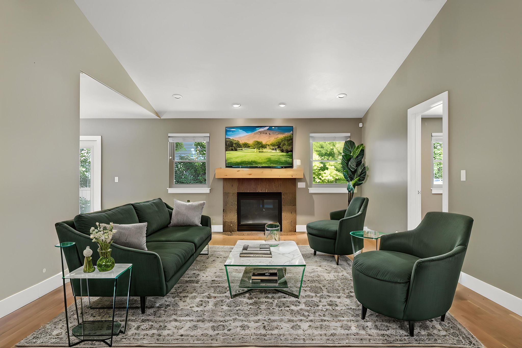 Living area featuring a fireplace with a wood mantle, hardwood flooring, and recessed lighting