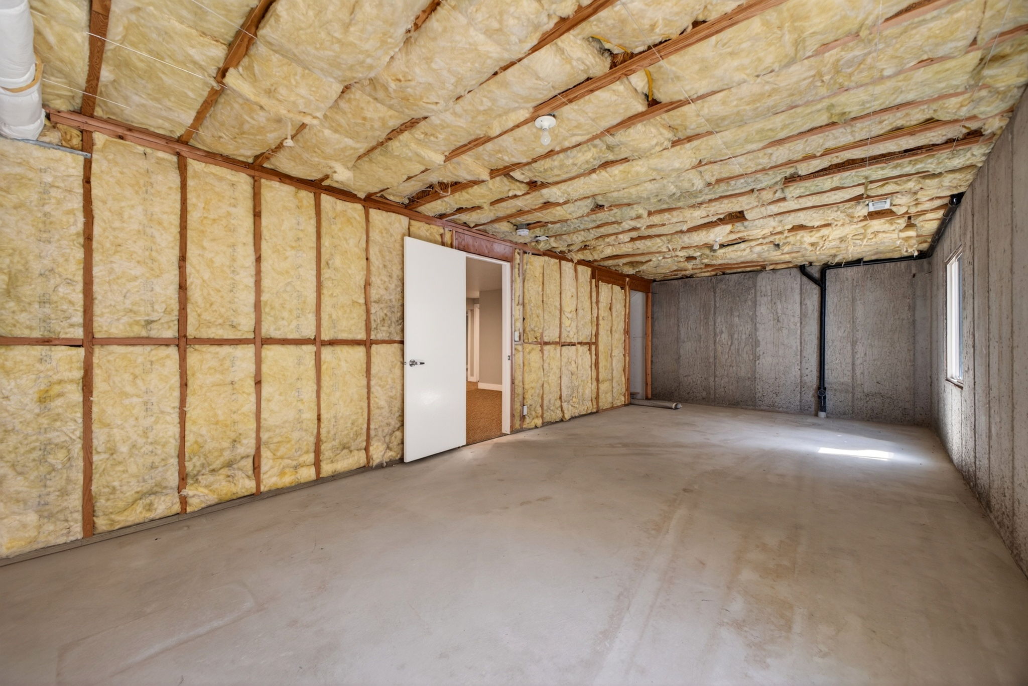 Unfinished basement storage space with window and endless potential