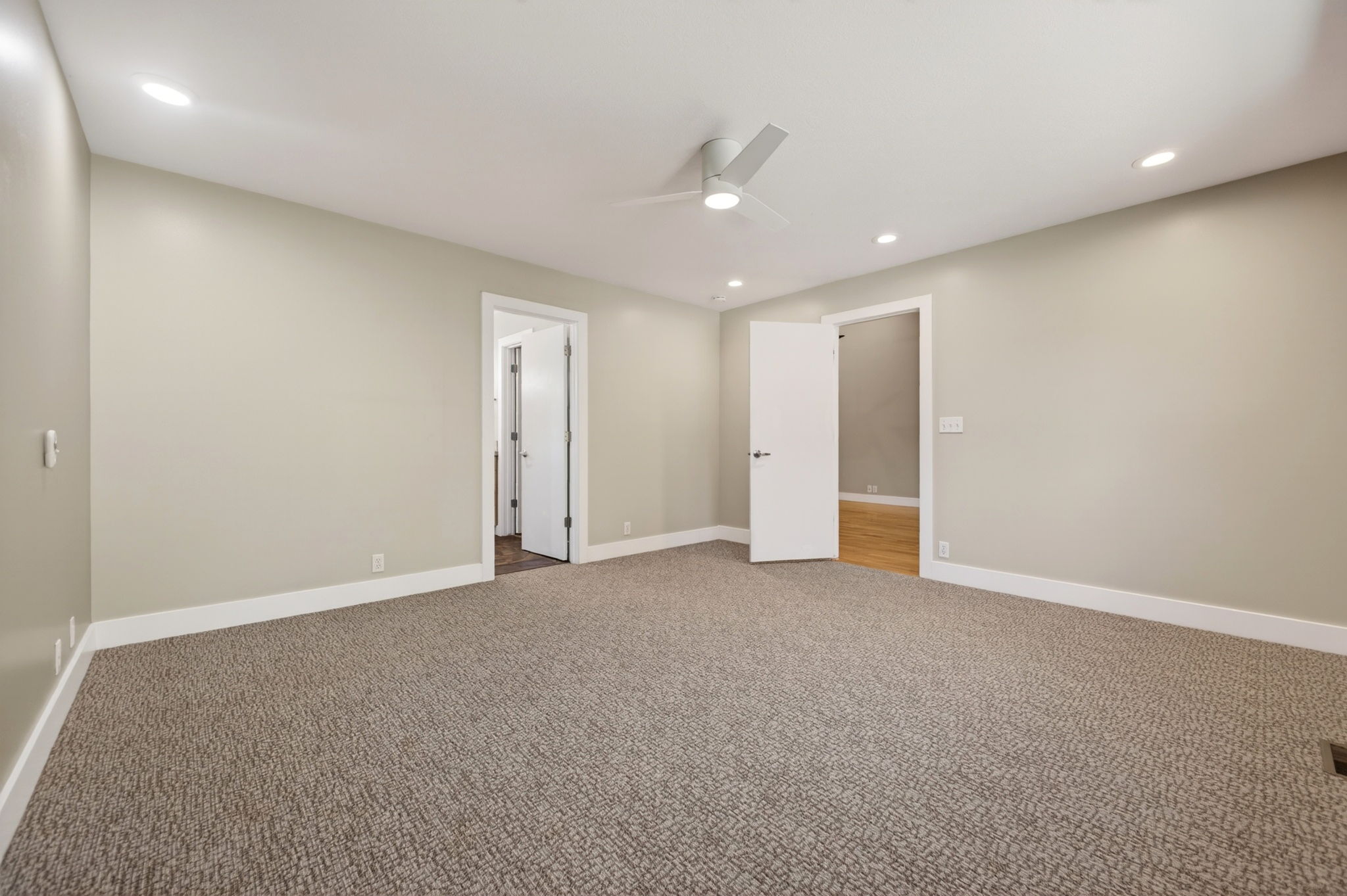 Large main bedroom with carpeting, recessed lighting, and a contemporary ceiling fan
