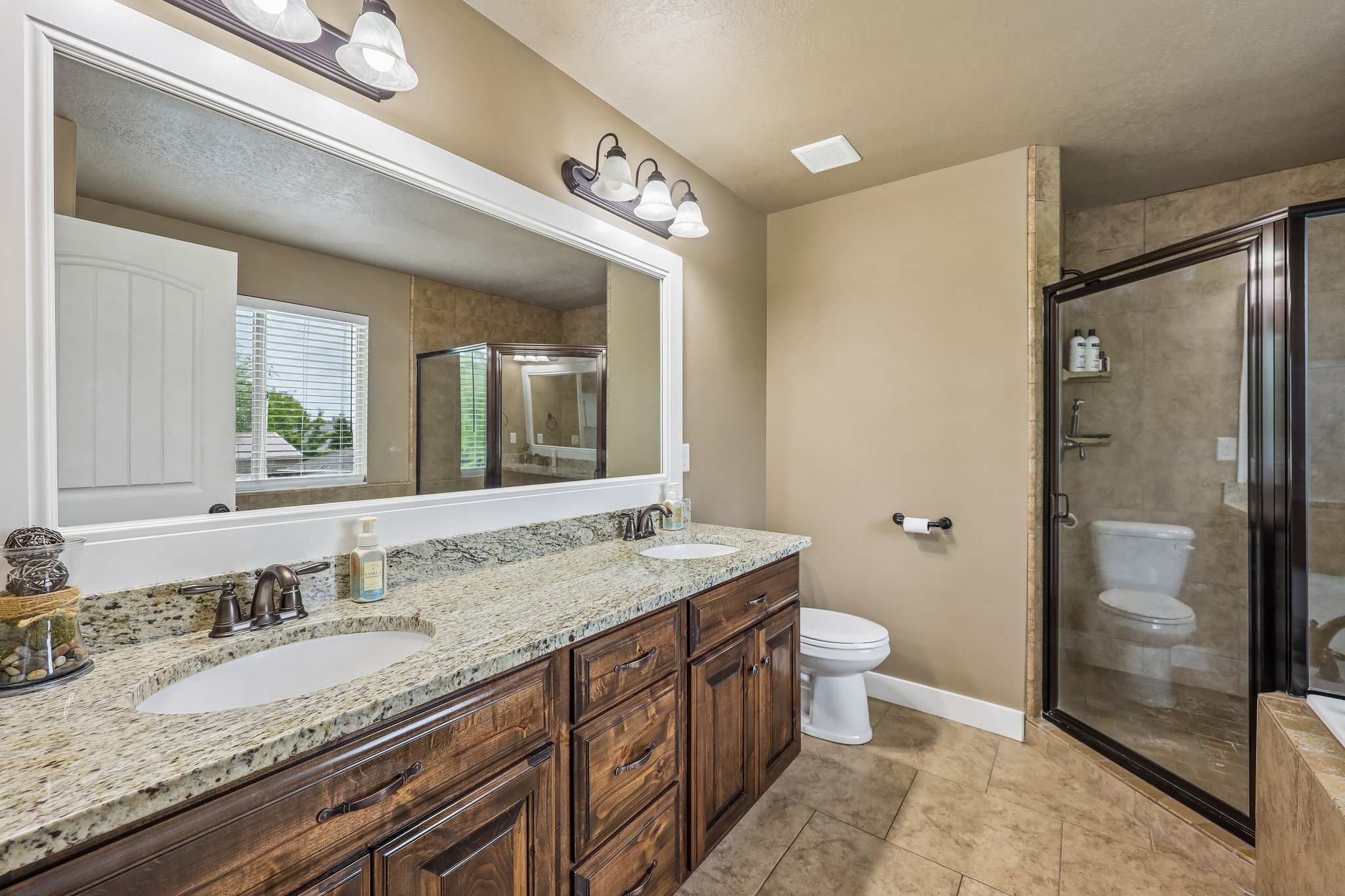 Double vanity with granite-finish countertop and undermount sinks