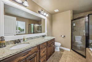 Double vanity with granite-finish countertop and undermount sinks