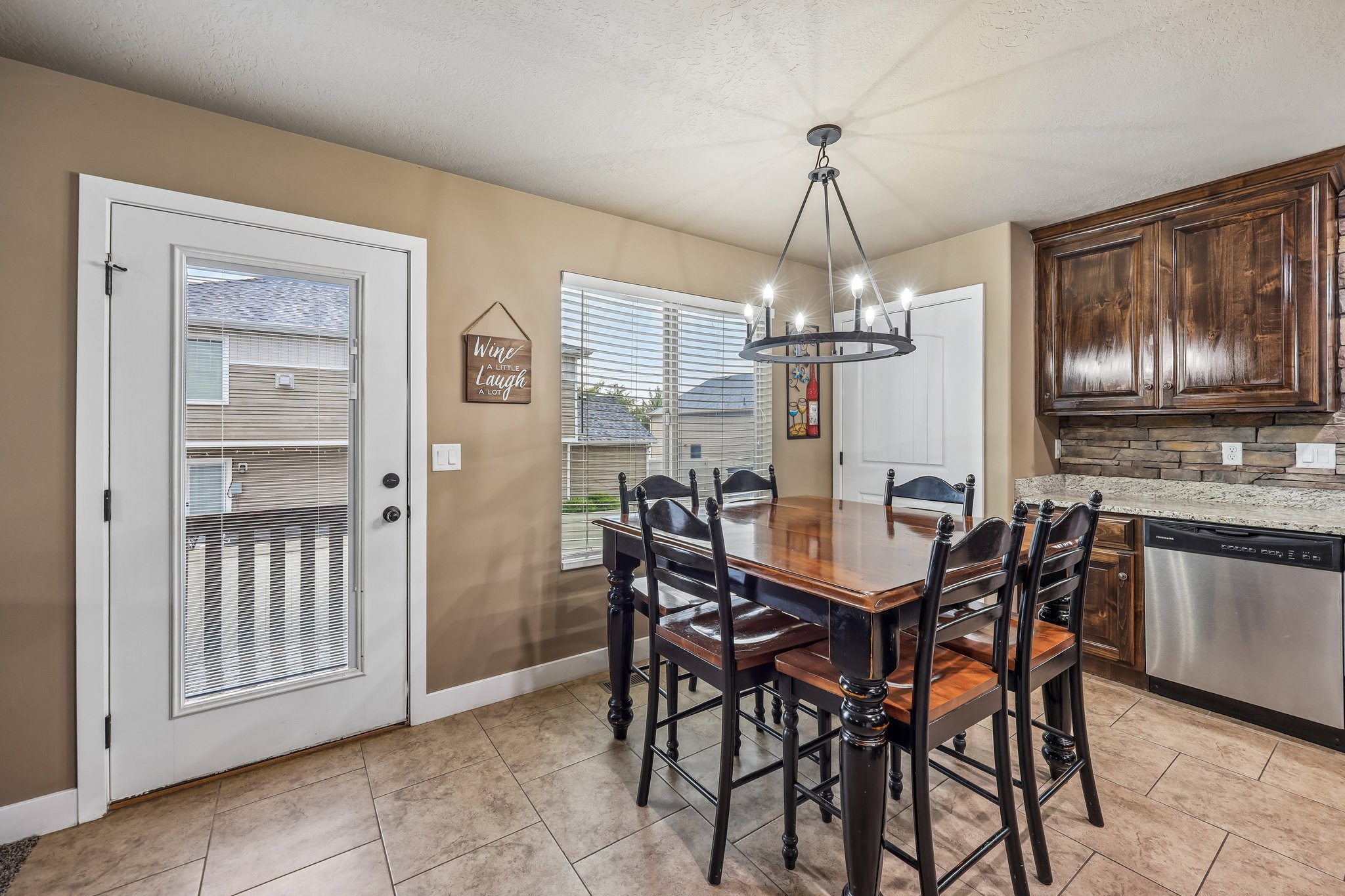 Dining area with tile flooring and a multi-light chandelier