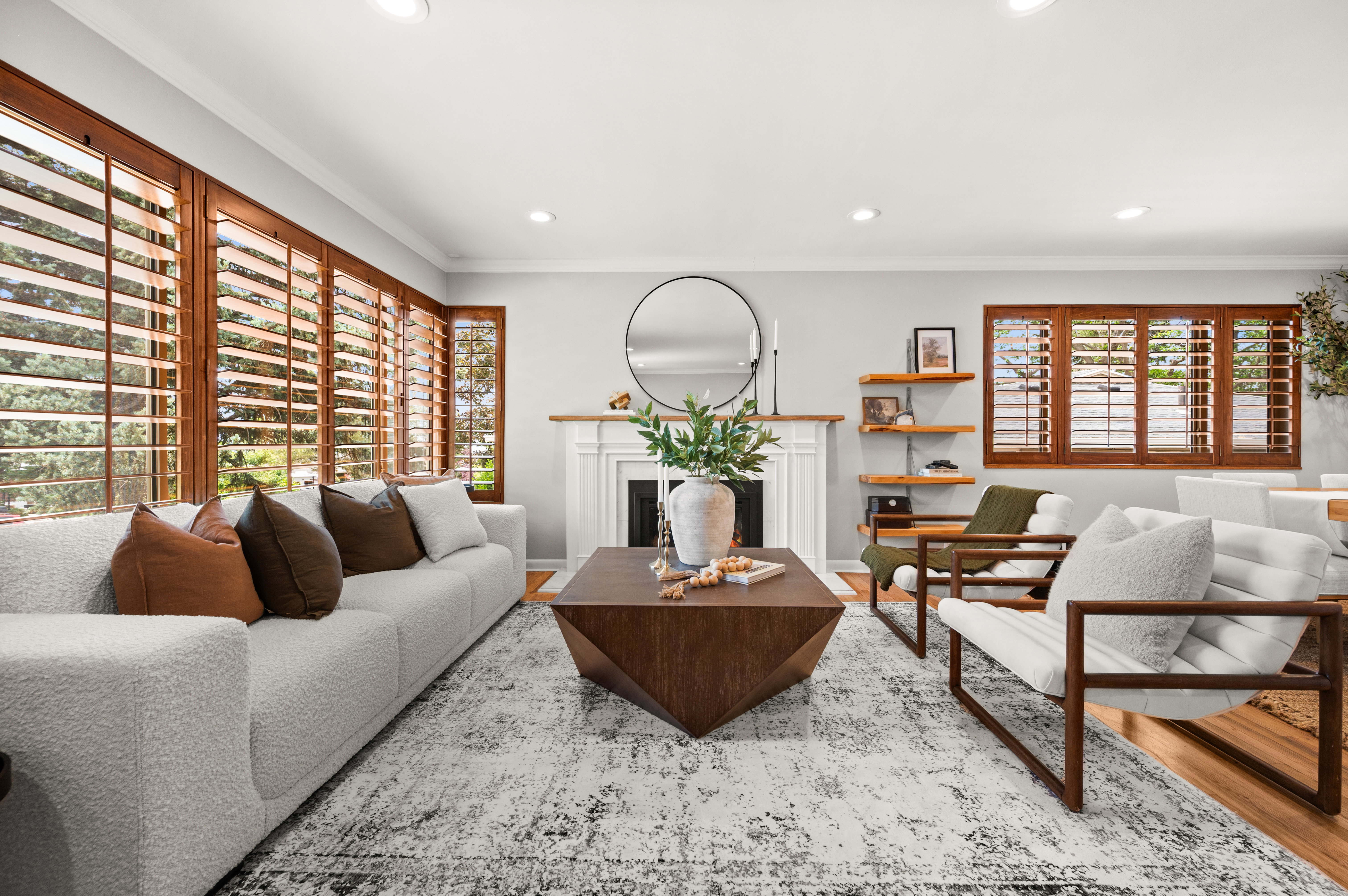 Bright living area featuring a white mantel fireplace, recessed lighting, and wood-finish flooring