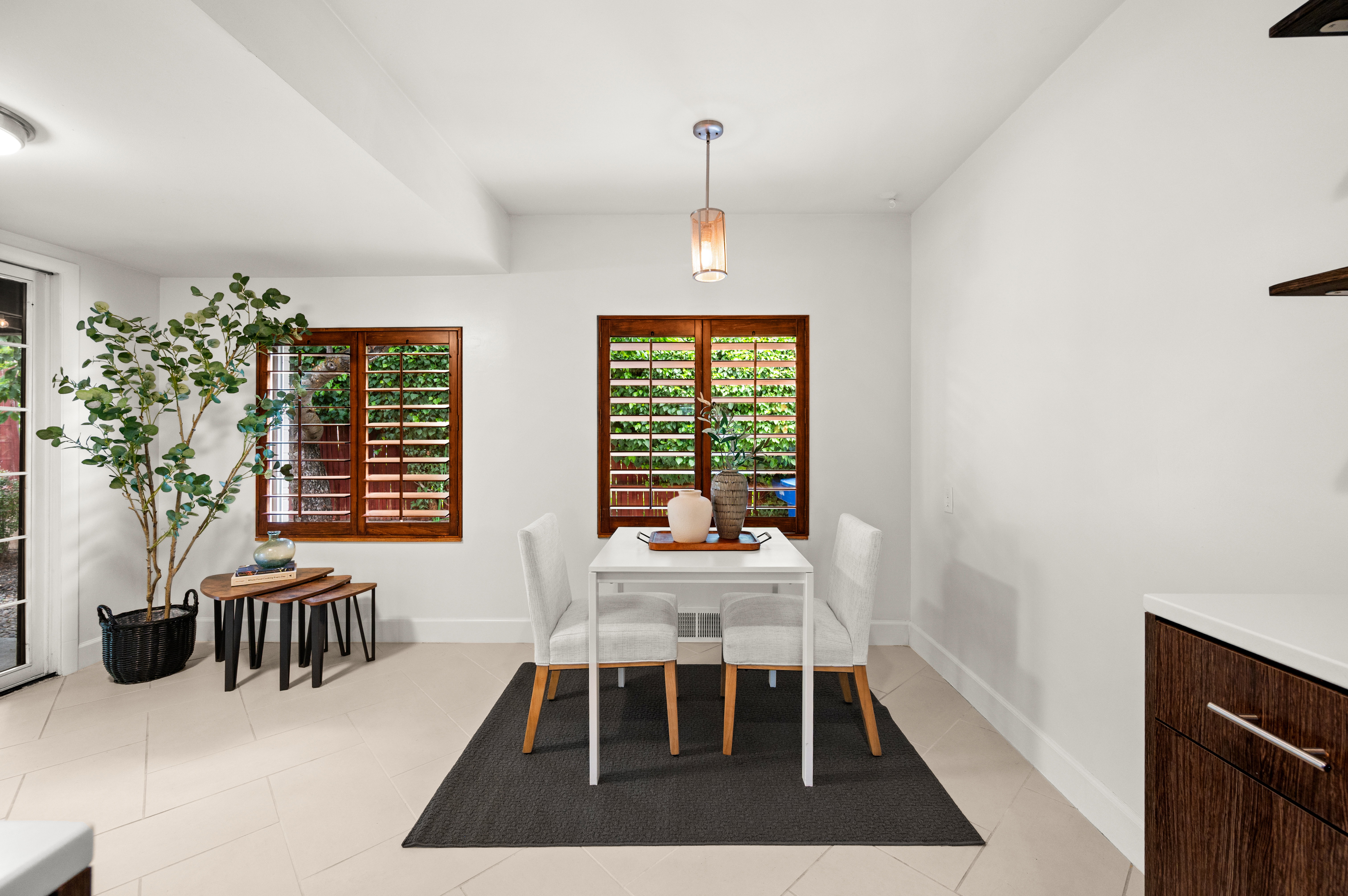 Dining area featuring light-toned tile flooring and white walls