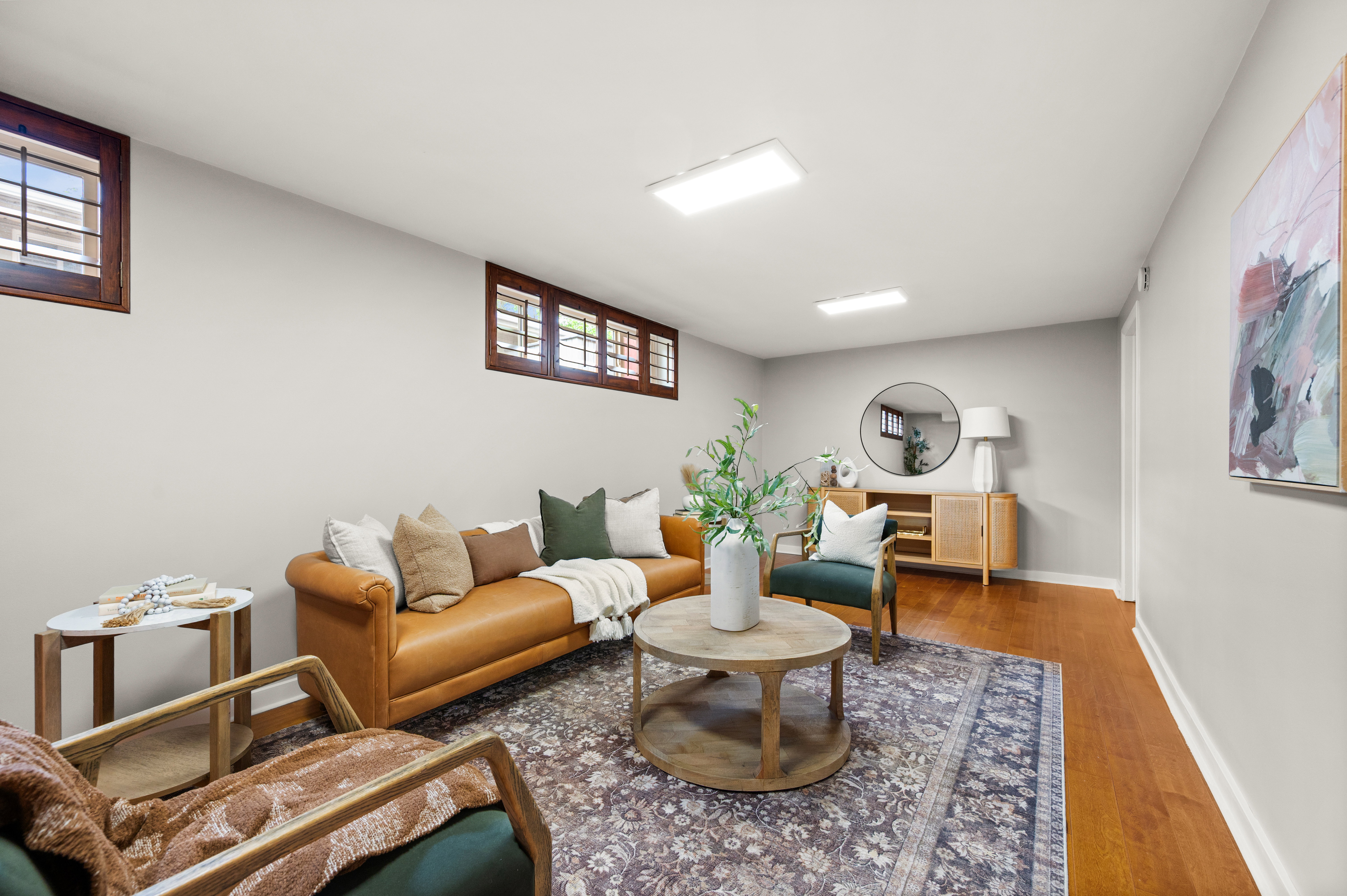 Living area featuring wood-finish flooring, light grey walls, and recessed lighting