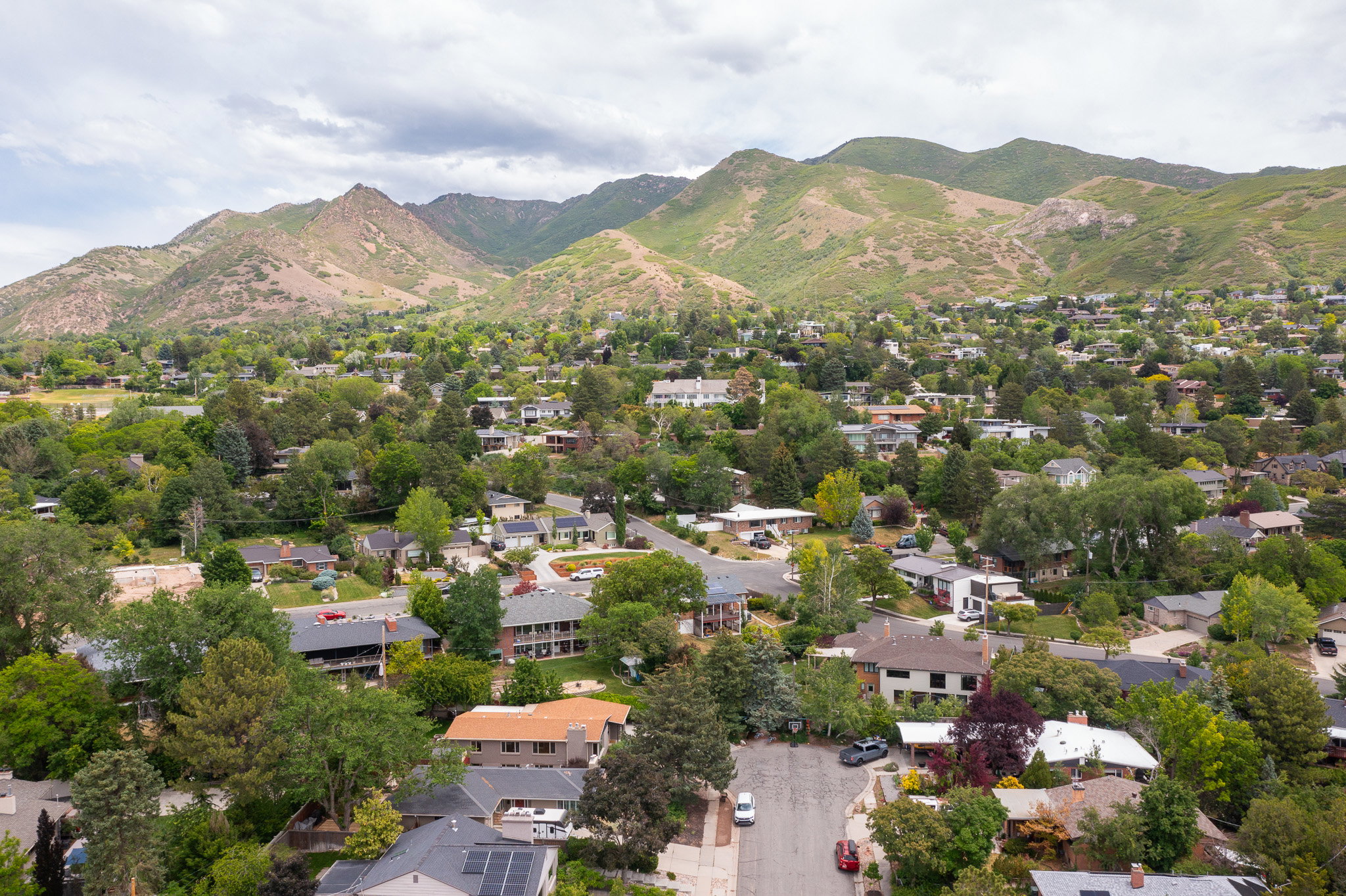Lush, green mountains providing a striking natural backdrop for this residential area