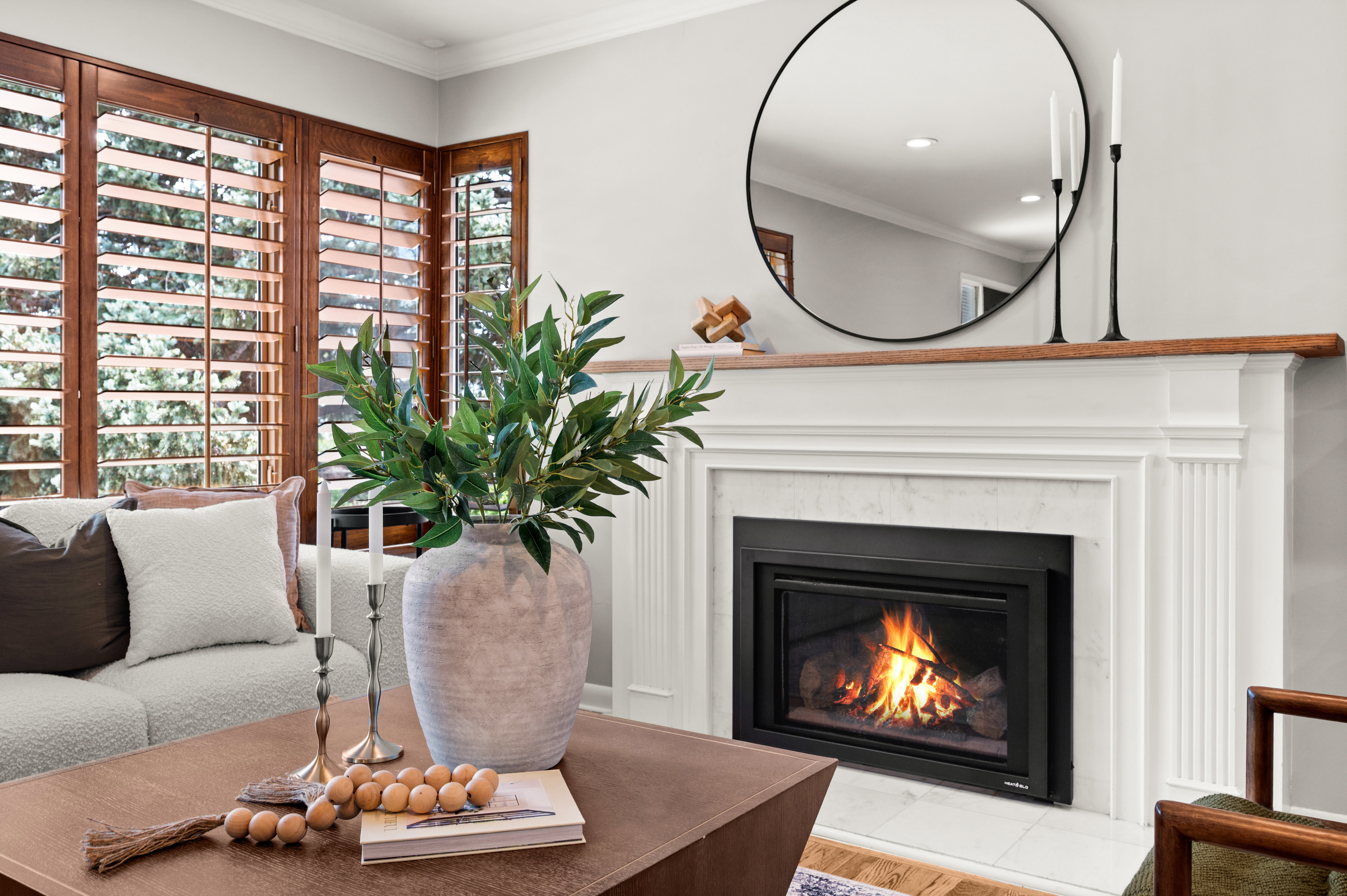 Built-in fireplace with a white mantel and wood-finish top