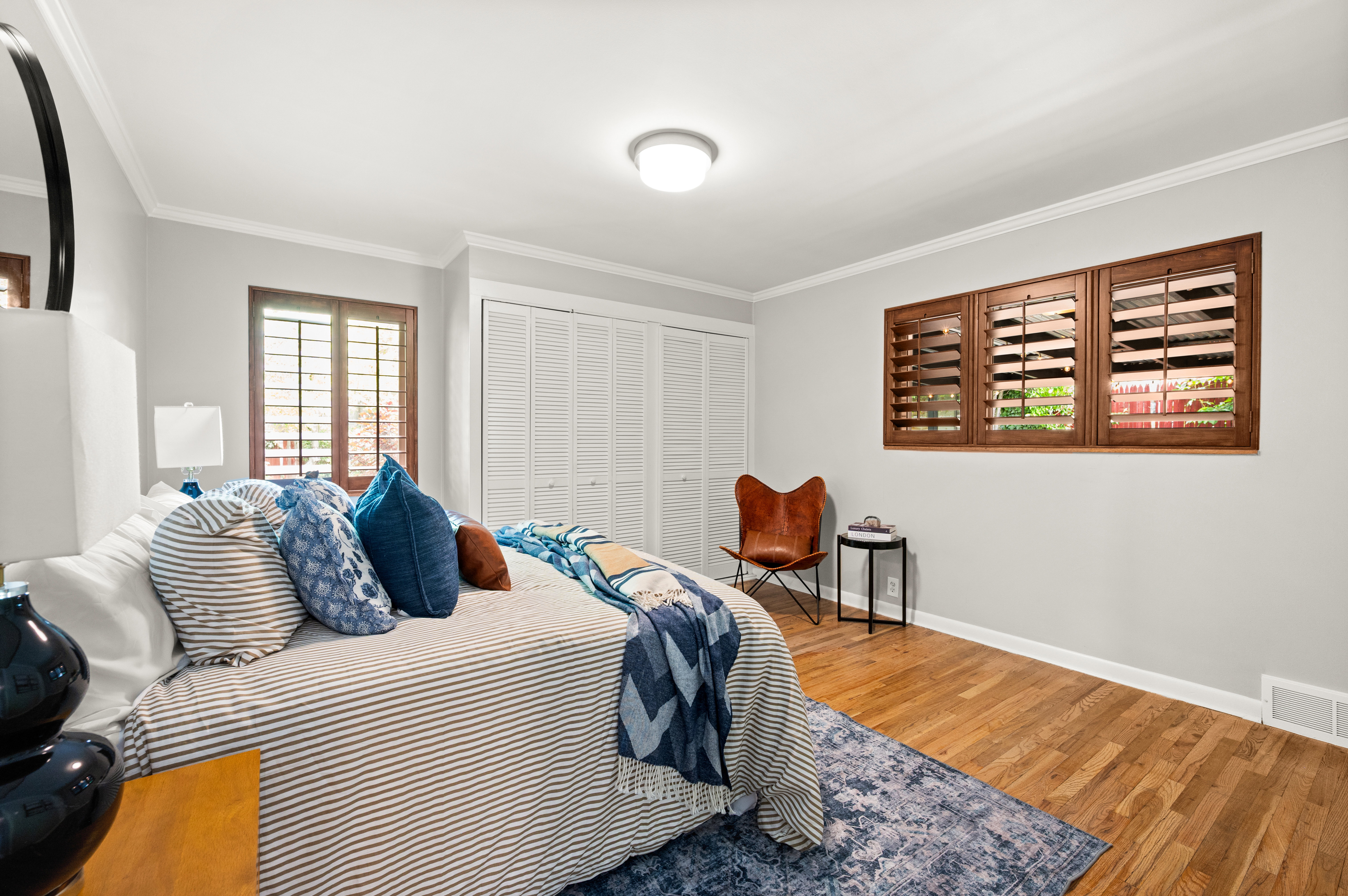 Hardwood flooring, painted walls, and crown molding define this bright room
