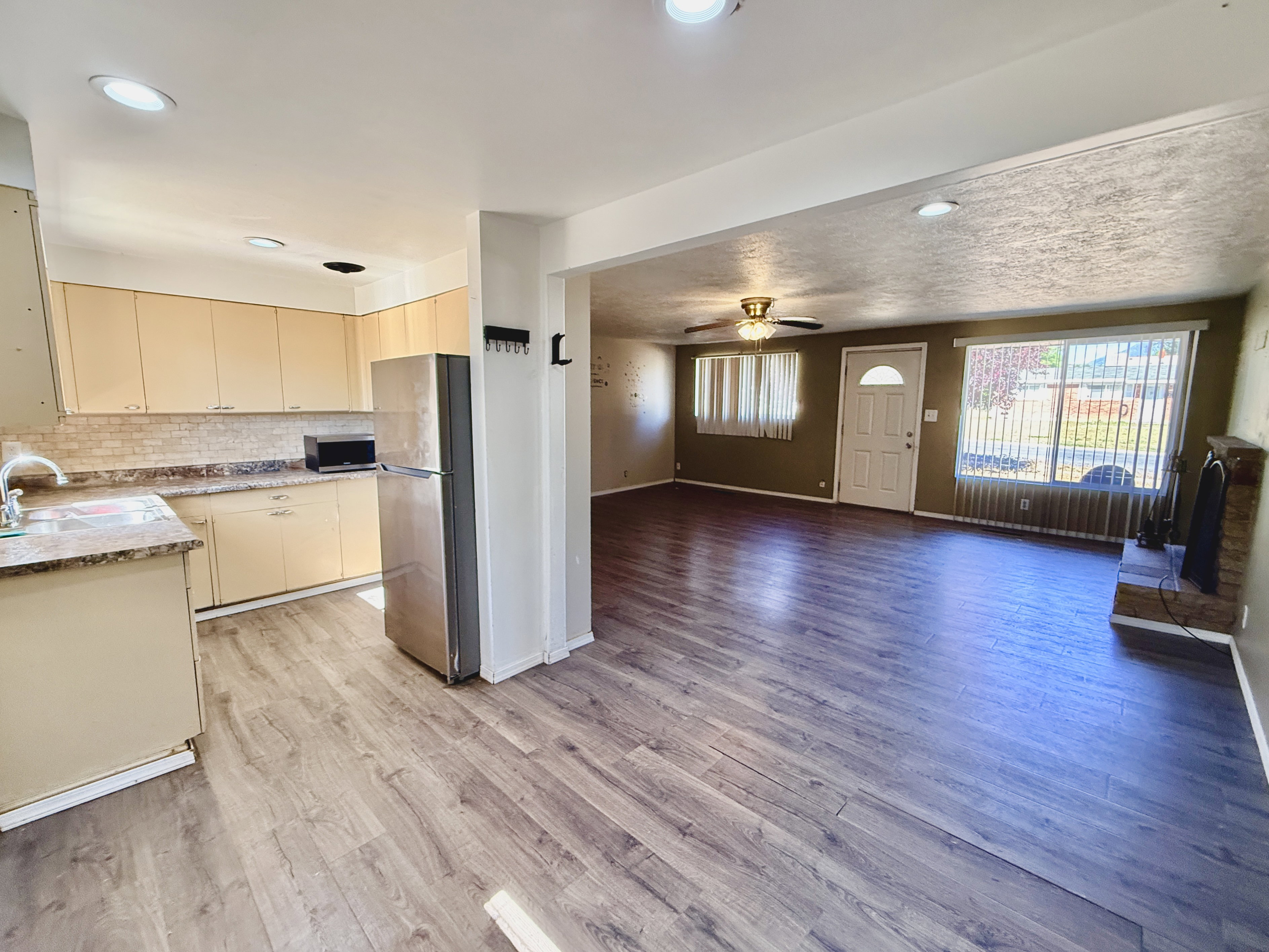 Open-concept living space featuring wood-finish flooring throughout