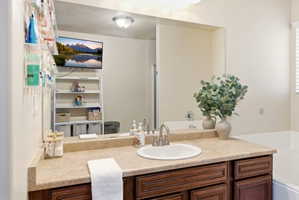 Bathroom vanity featuring an integrated sink, laminate countertop, and dark wood-finish cabinetry