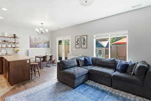 Open-concept living space featuring wood-finish flooring and light-toned walls