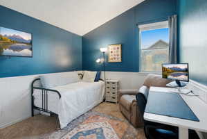 Room featuring wainscoting and a high ceiling