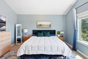 Spacious room featuring light blue walls, white trim, and carpeted flooring
