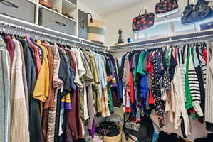 Spacious walk-in closet featuring an upper window