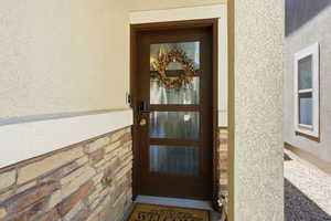 Entry door featuring multiple glass panels, dark framing, and modern hardware