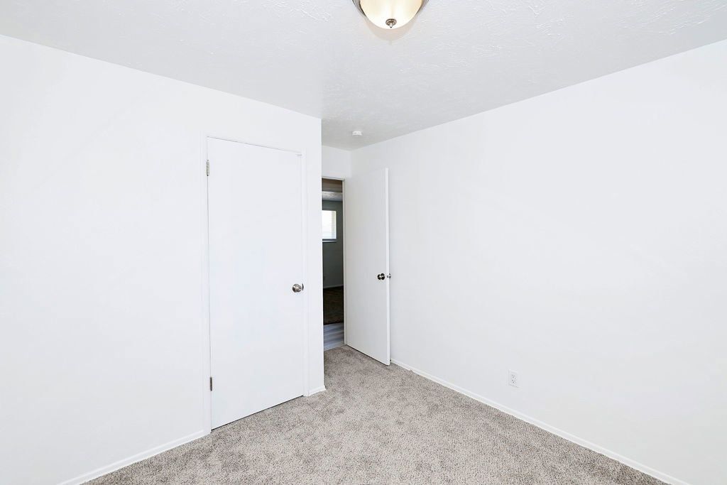 Carpeted interior space featuring neutral wall tones