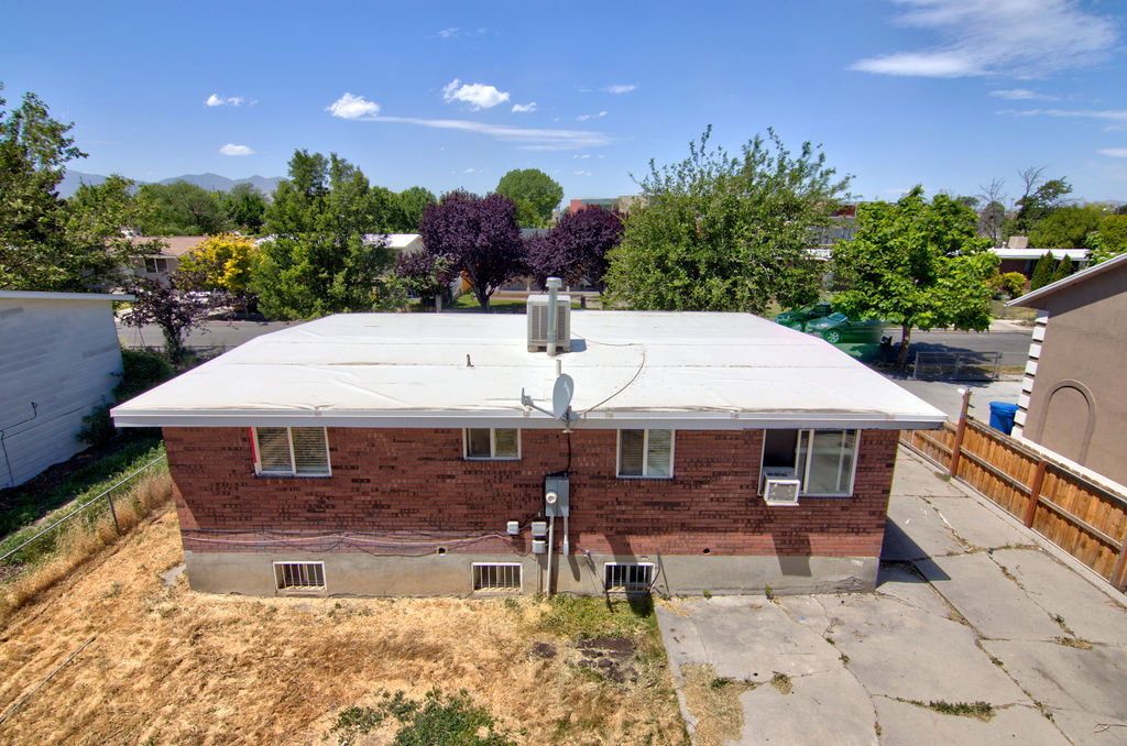 Brick exterior with a white flat roof