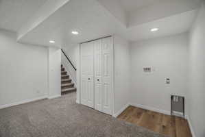 Versatile lower-level space featuring recessed lighting and a neutral color palette