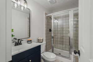 Bathroom with a dark blue vanity, white countertop, and integrated sink