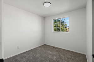 Bedroom 3 Room featuring light gray carpeting, neutral white walls, a single window with white trim, and a flush-mount ceiling light fixture