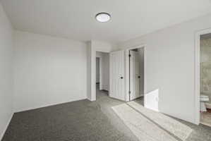 Primary Bedroom Carpeted room featuring white walls and a flush-mount ceiling light