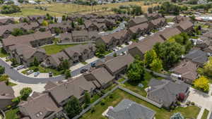 Attached homes with private driveways, green space between units, and mature tree canopy throughout. Consistent architecture and a true neighborhood feel.