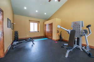 Second angle of the fitness center reveals additional equipment including a full dumbbell rack, adjustable bench, and cable cross machine. Knotty alder doors and trim continue the community's quality finishes throughout.