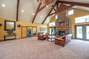 Full wide angle of the clubhouse great room reveals the true scale of this impressive space. Soaring exposed beam vaulted ceilings, stone fireplace, leather seating, and direct access to both the fitness room and pool patio. This is a serious amenity.