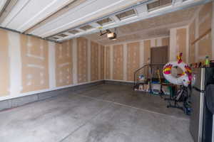 Spacious two-car garage with drywalled walls, concrete floor, automatic opener, and direct interior access. Clean, open, and ready to work with.