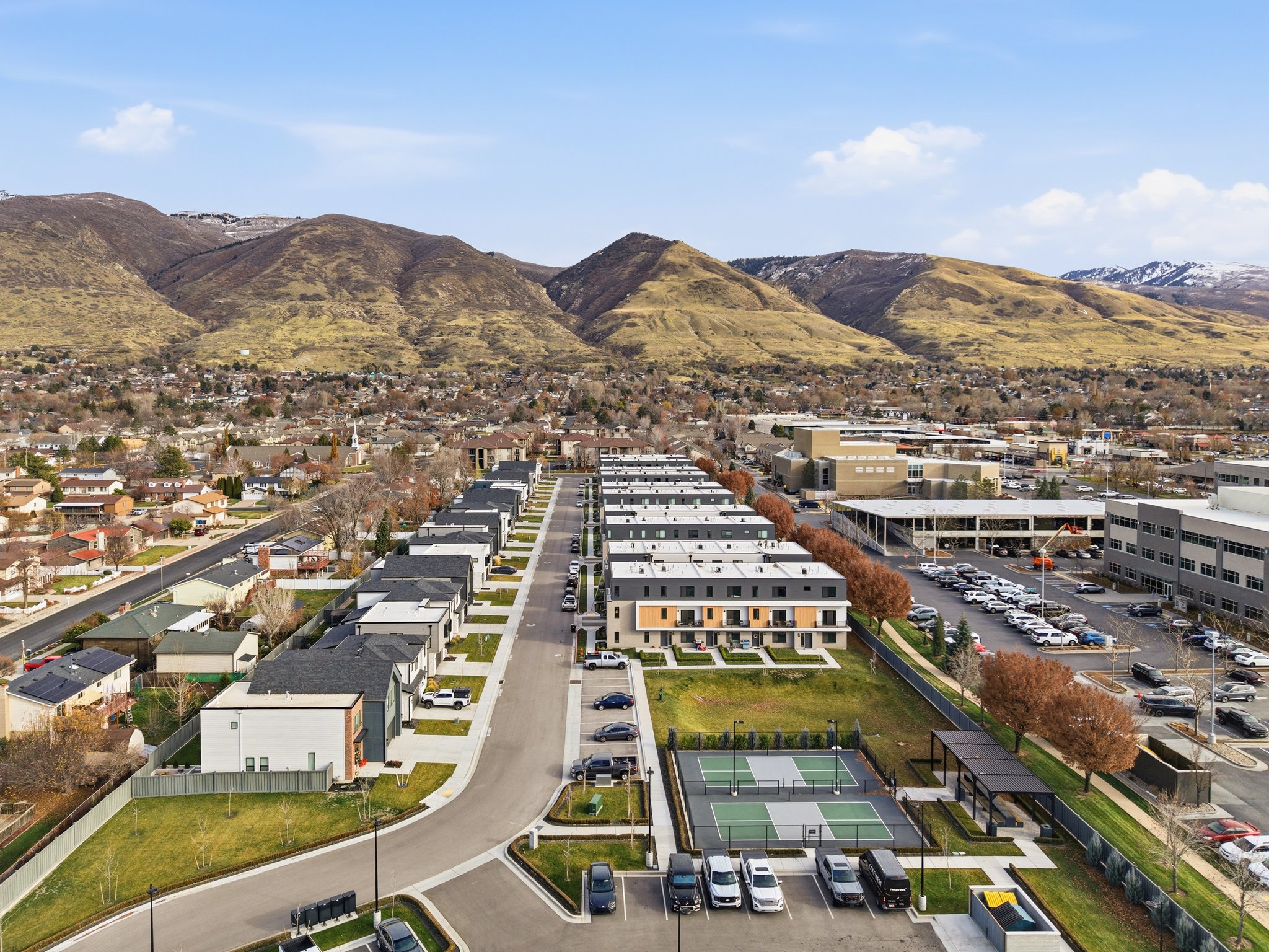 Modern townhouse development featuring organized rows of residences with flat roofs and varying facade treatments