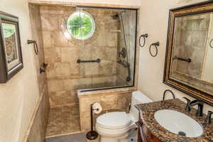 Walk-in shower with full-height tile surround and circular accent window
