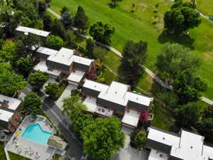 Townhome community featuring brick exteriors, white flat roofs, and attached garages