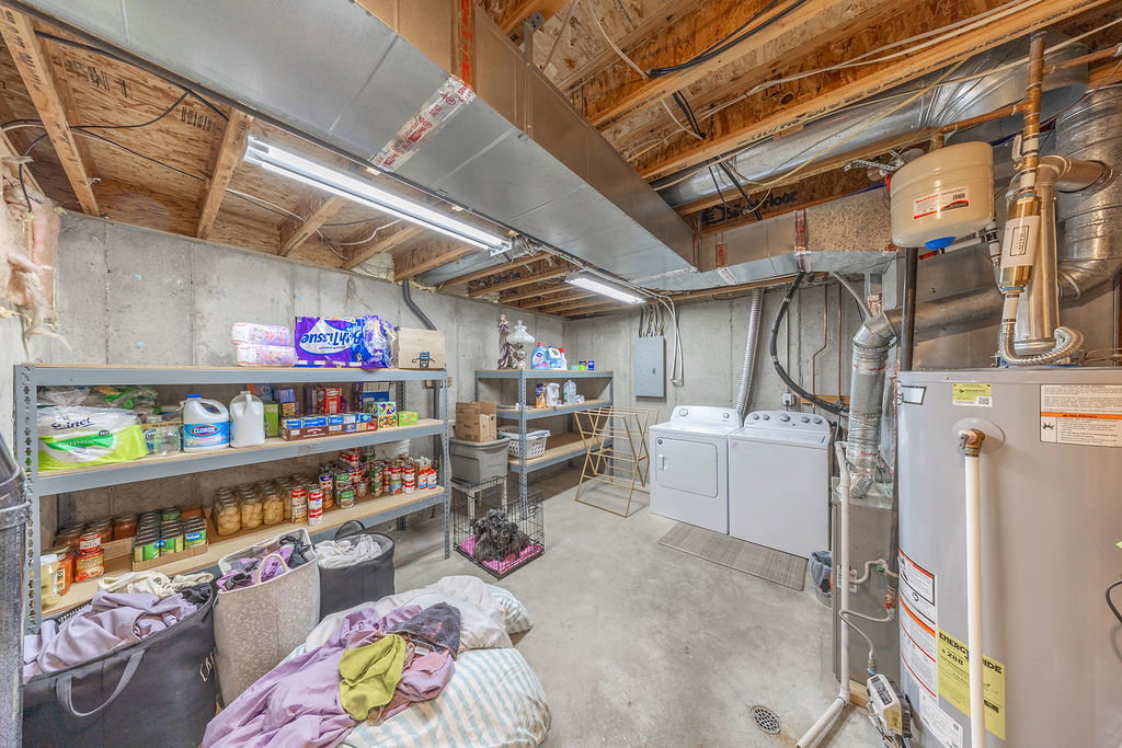 Utility area featuring concrete flooring and exposed ceiling joists