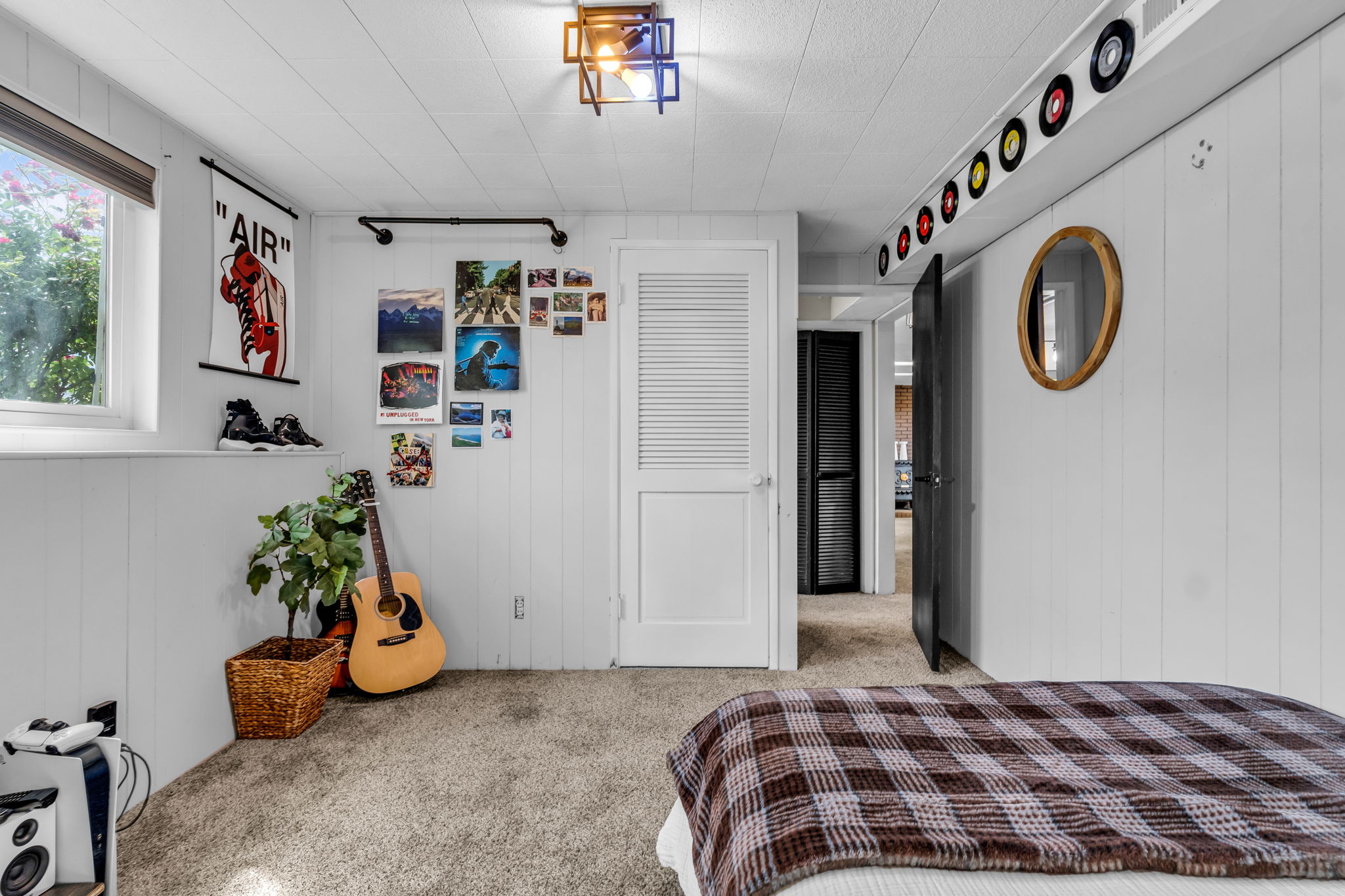 Carpeted room featuring white paneled walls and a white paneled ceiling