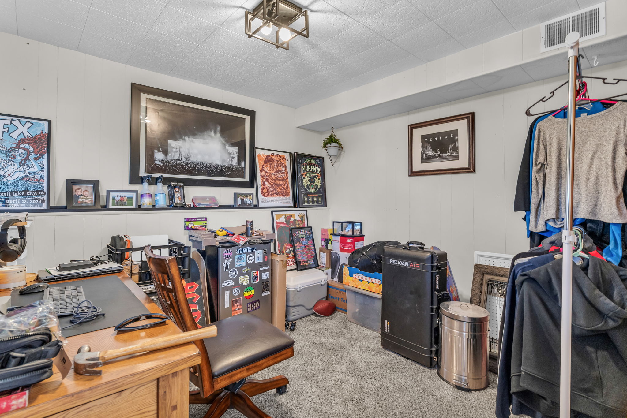 Carpeted room featuring white paneled walls and a drop ceiling with recessed lighting